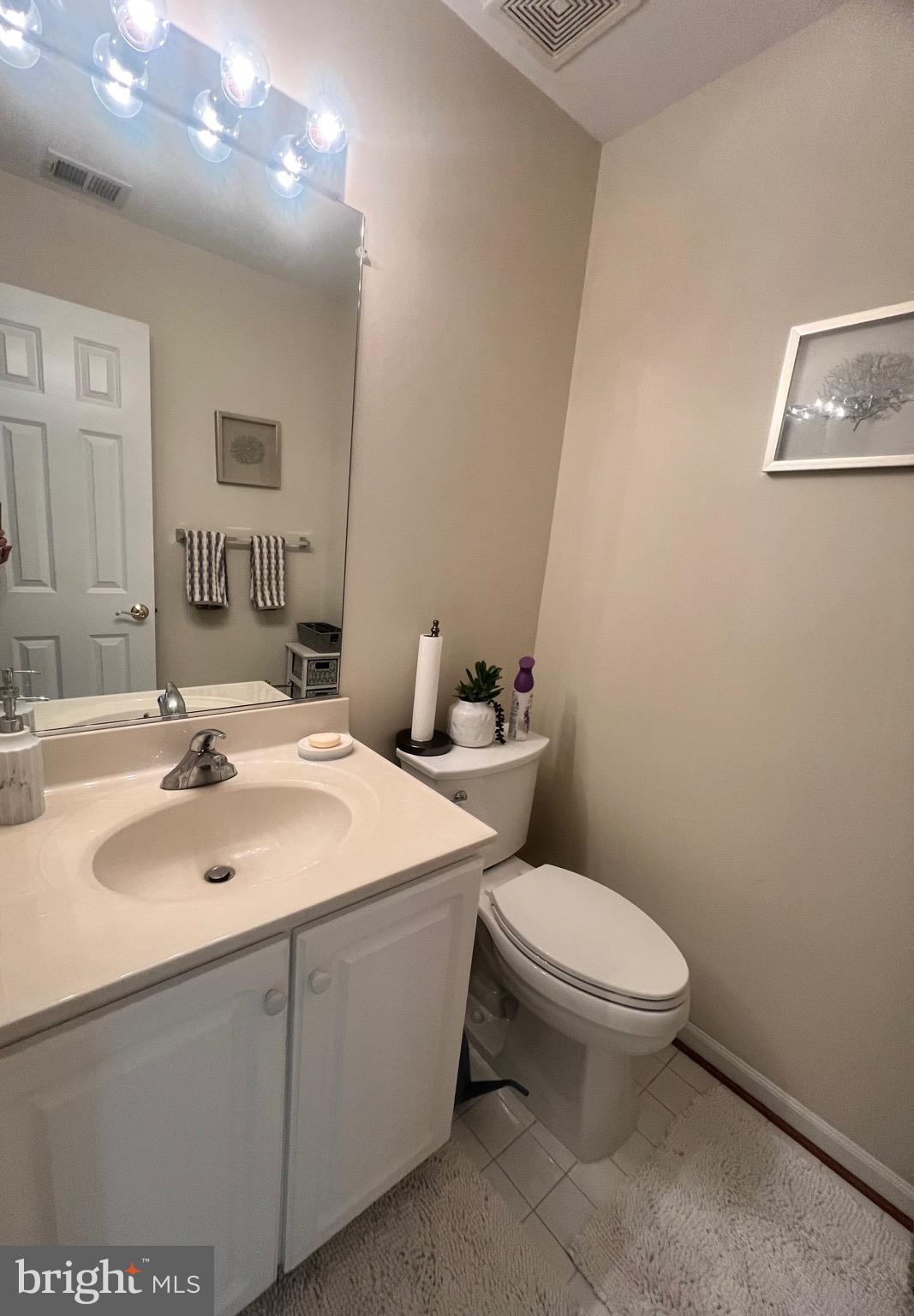 7317 Hampton Manor Place Springfield, VA 22150 - Photo 22 of 38 a bathroom with a toilet sink and mirror