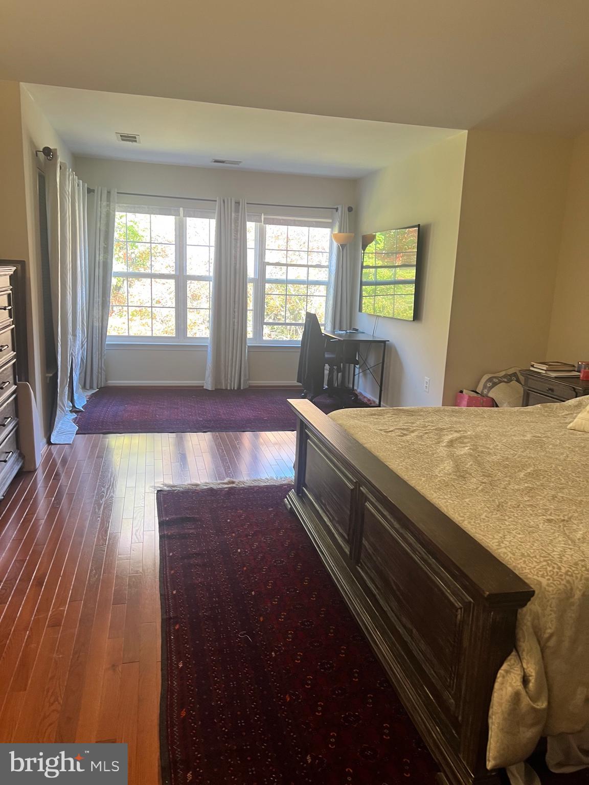 7317 Hampton Manor Place Springfield, VA 22150 - Photo 23 of 38 a bed sitting in a bedroom next to a window