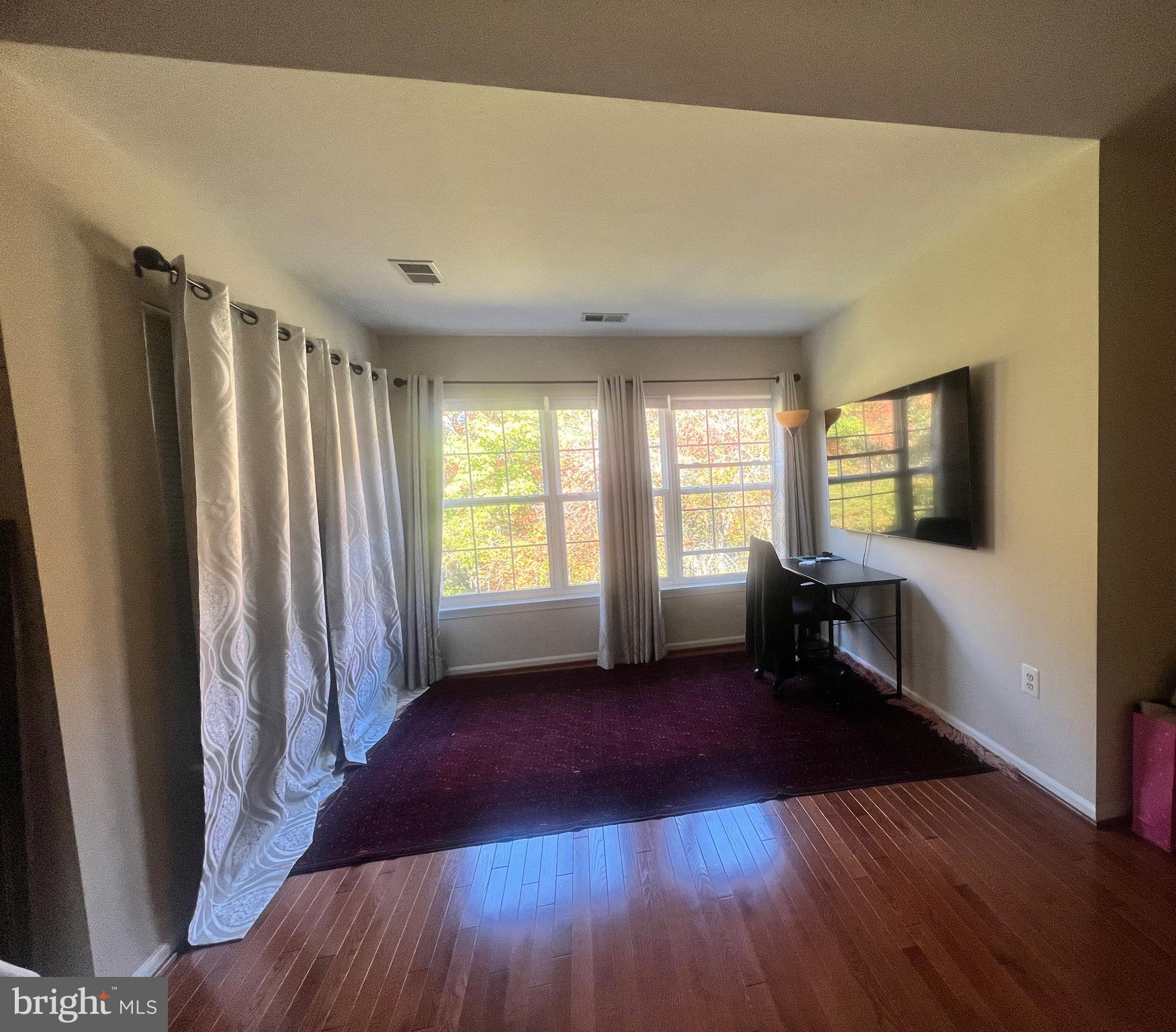 7317 Hampton Manor Place Springfield, VA 22150 - Photo 24 of 38 an empty room with wooden floor and windows