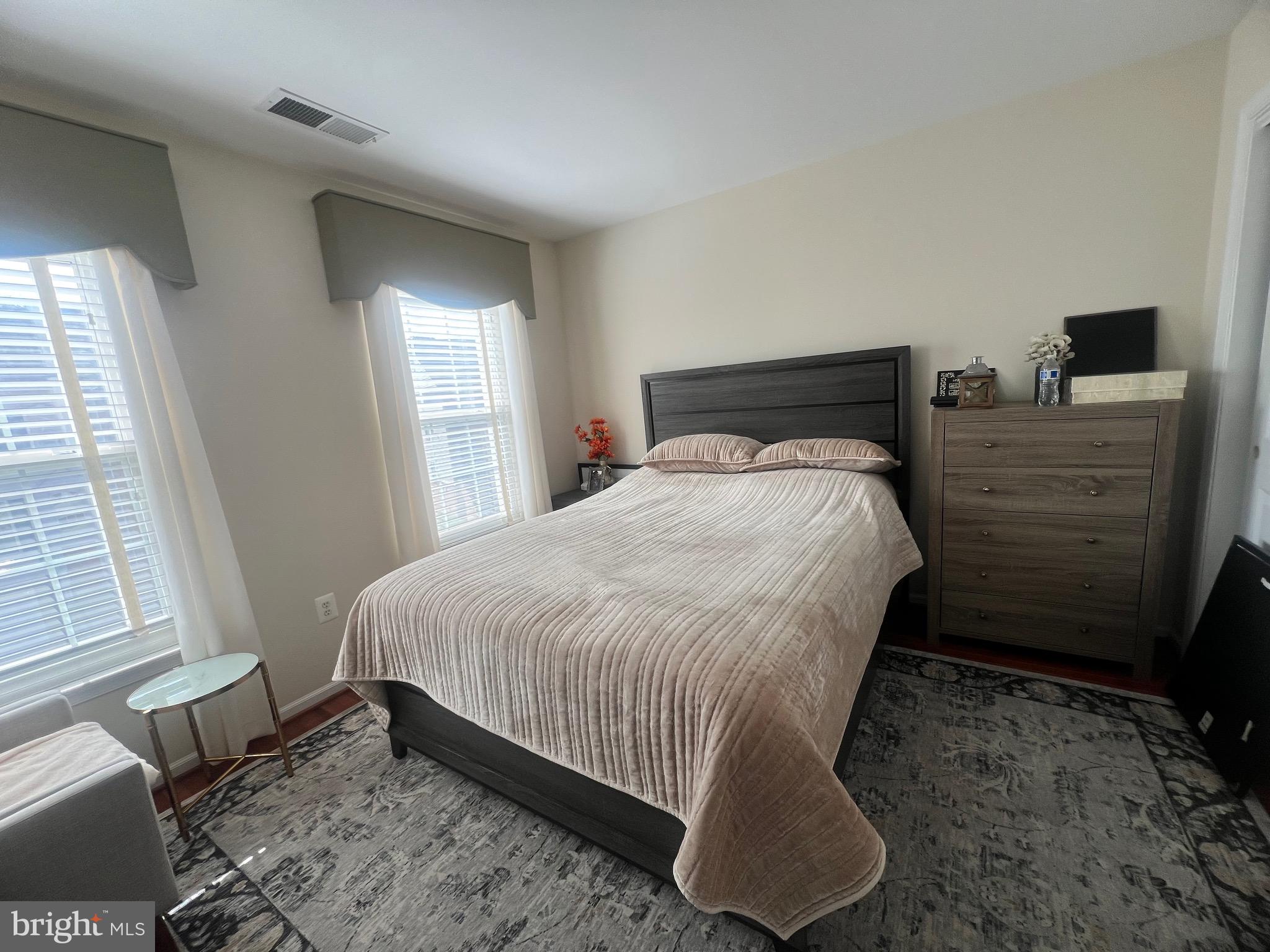 7317 Hampton Manor Place Springfield, VA 22150 - Photo 28 of 38 a bed sitting in a bedroom next to a window
