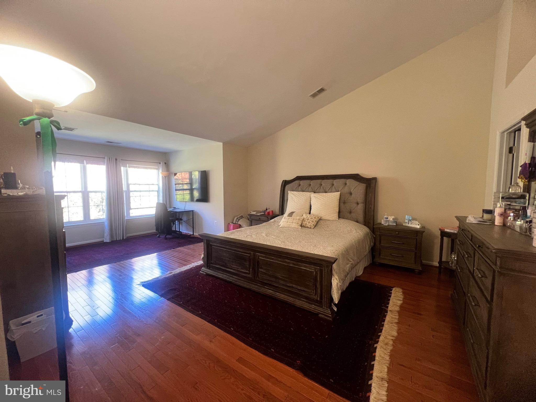 7317 Hampton Manor Place Springfield, VA 22150 - Photo 29 of 38 a bedroom with a bed and wooden floor