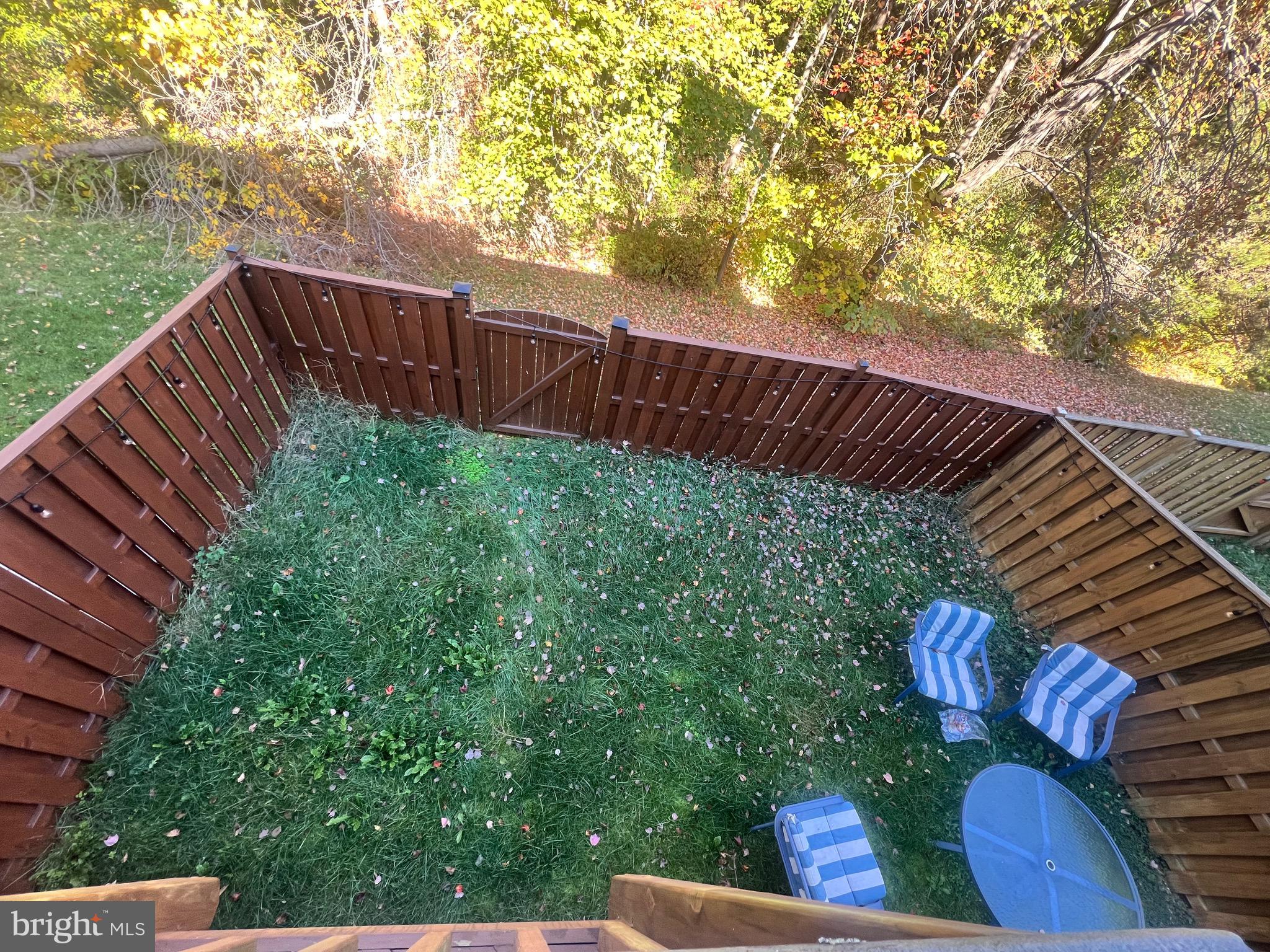 7317 Hampton Manor Place Springfield, VA 22150 - Photo 33 of 38 a view of a roof deck with couches and wooden fence
