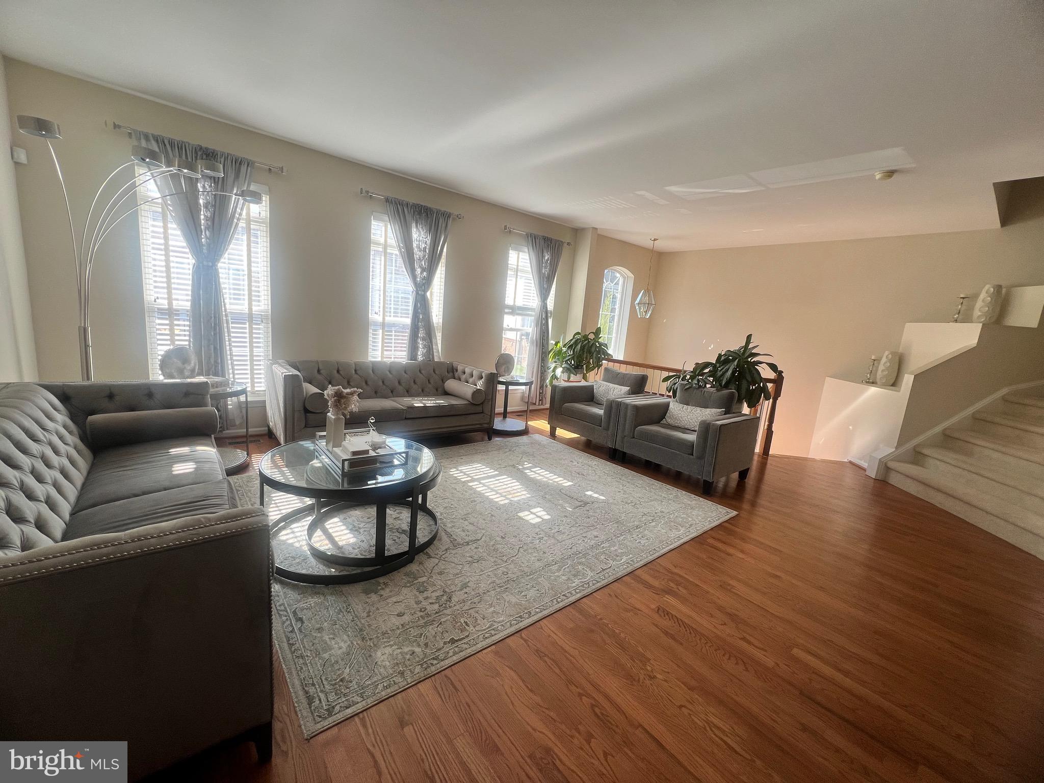 7317 Hampton Manor Place Springfield, VA 22150 - Photo 4 of 38 a living room with furniture and a large window