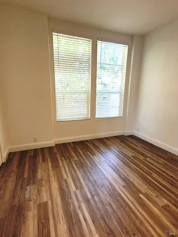 a view of a chair and table on the side of the house