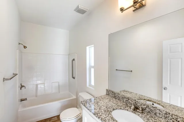 a room with furniture a rug and a window