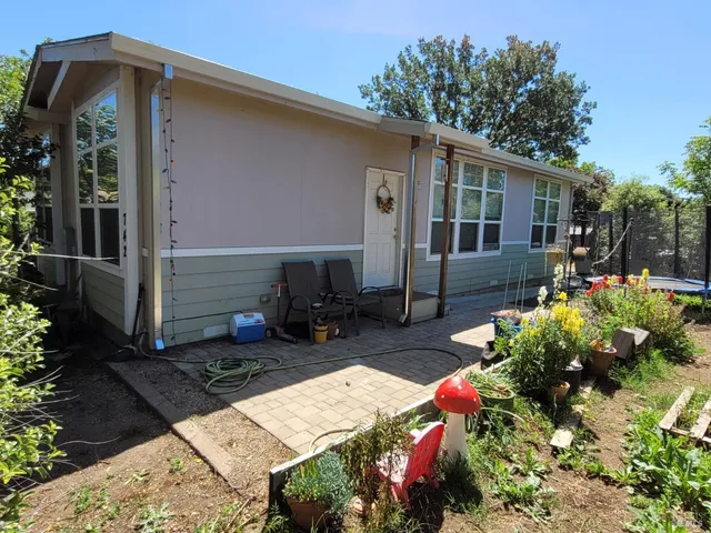 a kitchen with a refrigerator and a stove top oven