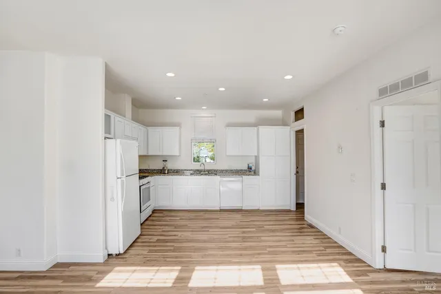 a view of hallway with wooden floor