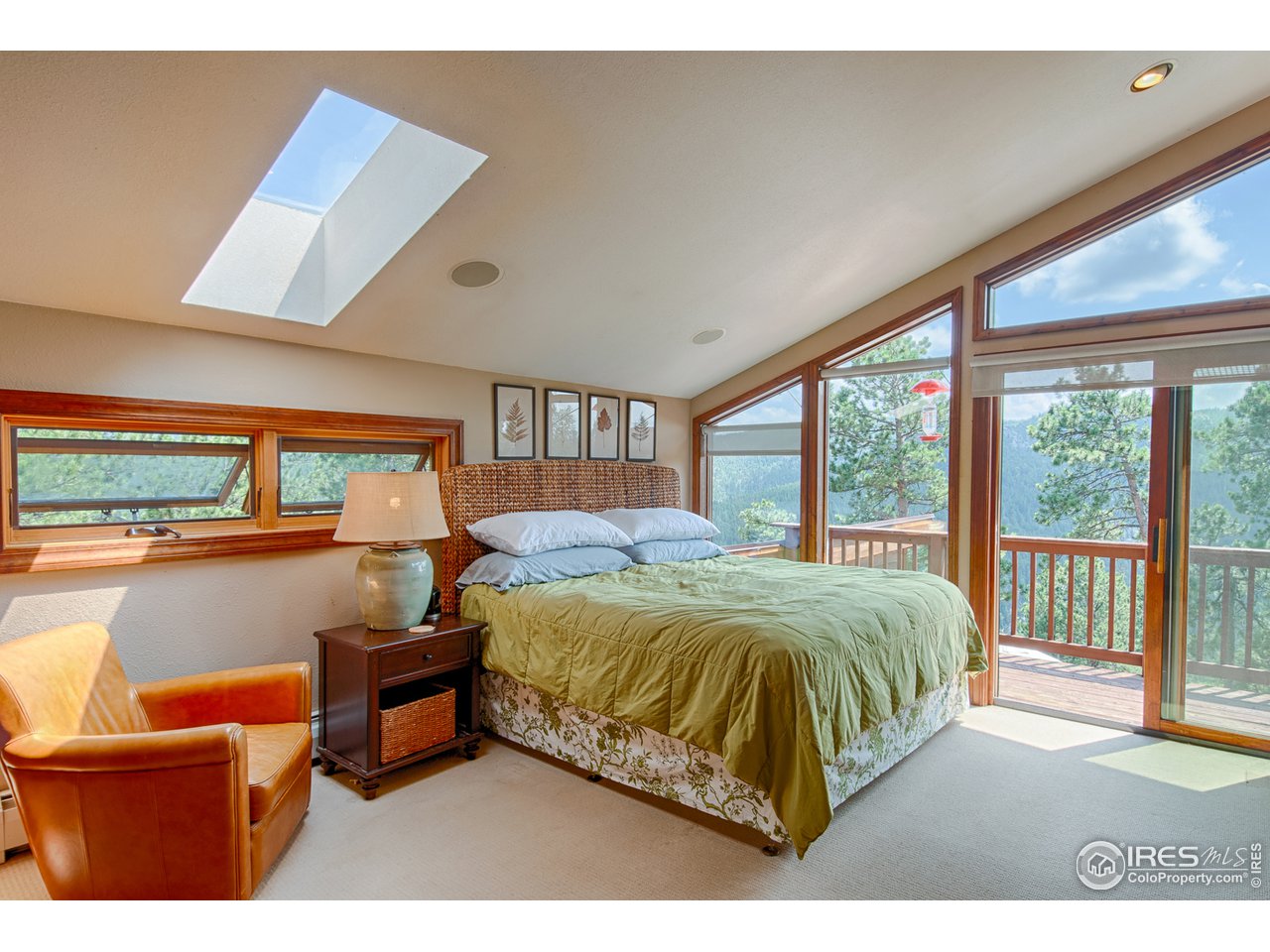3464 Ridge Road Nederland, CO 80466 - Photo 15 of 35 a bedroom with a bed and glass window