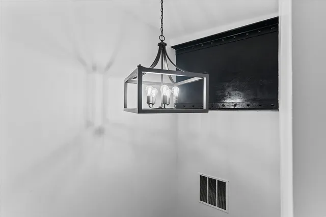 a view of a room with wooden floor and a flat screen tv