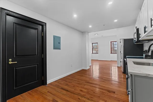 a view of a kitchen with a sink and a refrigerator
