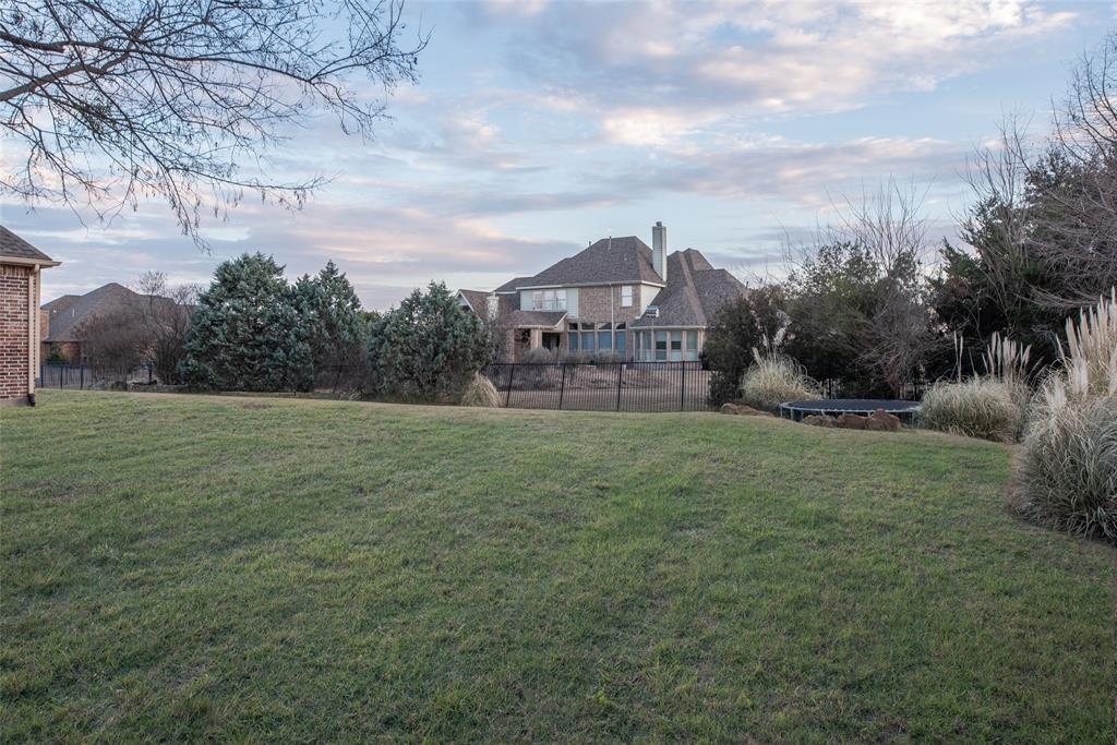 811 Red Store Court Lucas, TX 75002 - Photo 29 of 31 a view of a big house with a big yard and large trees