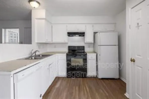 a kitchen with a sink and a refrigerator