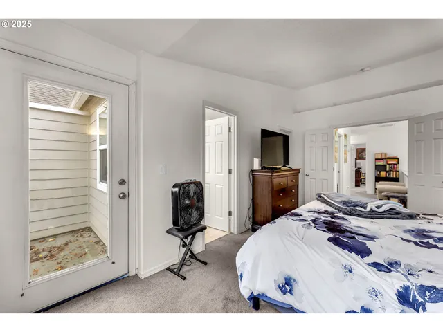 a bedroom with a bed and a view of living room