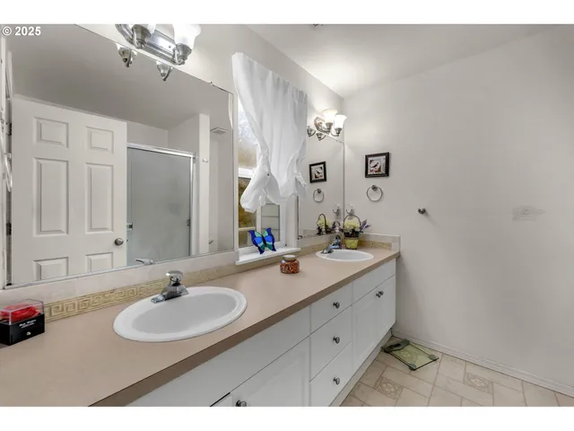 a bathroom with a sink double vanity and a mirror
