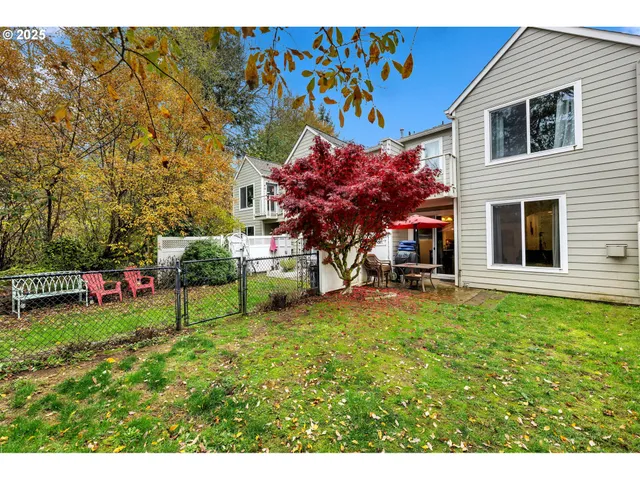 a view of a house with a backyard and sitting area
