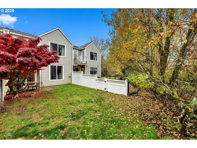 a view of a house with backyard and sitting area