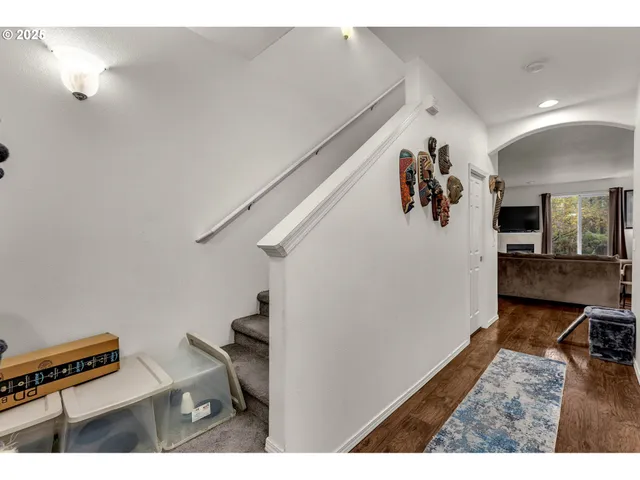 a view of a hallway with workspace and wooden floor