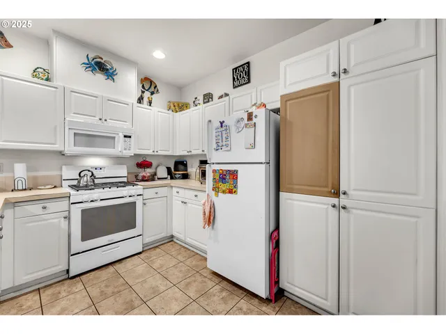 a kitchen with refrigerator and cabinets