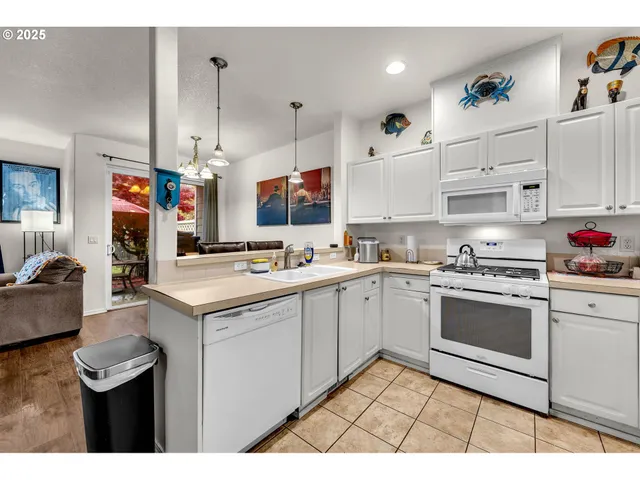 a kitchen with a sink cabinets and stainless steel appliances