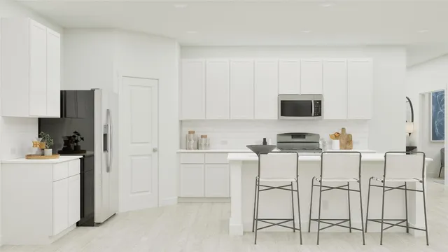 a kitchen with cabinets and chairs