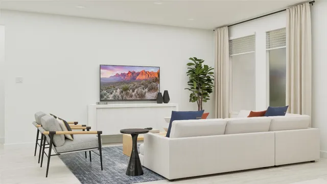 a living room with furniture and a potted plant