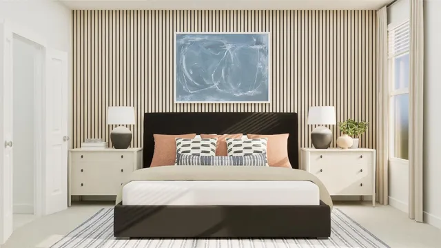 a bedroom with a bed and a painting on the wall
