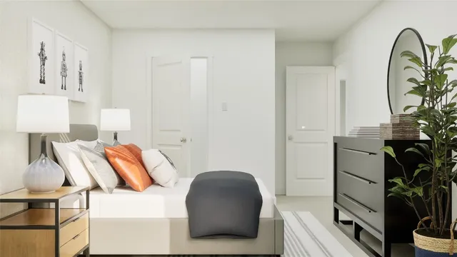 a bedroom with a bed and a potted plant on the dresser