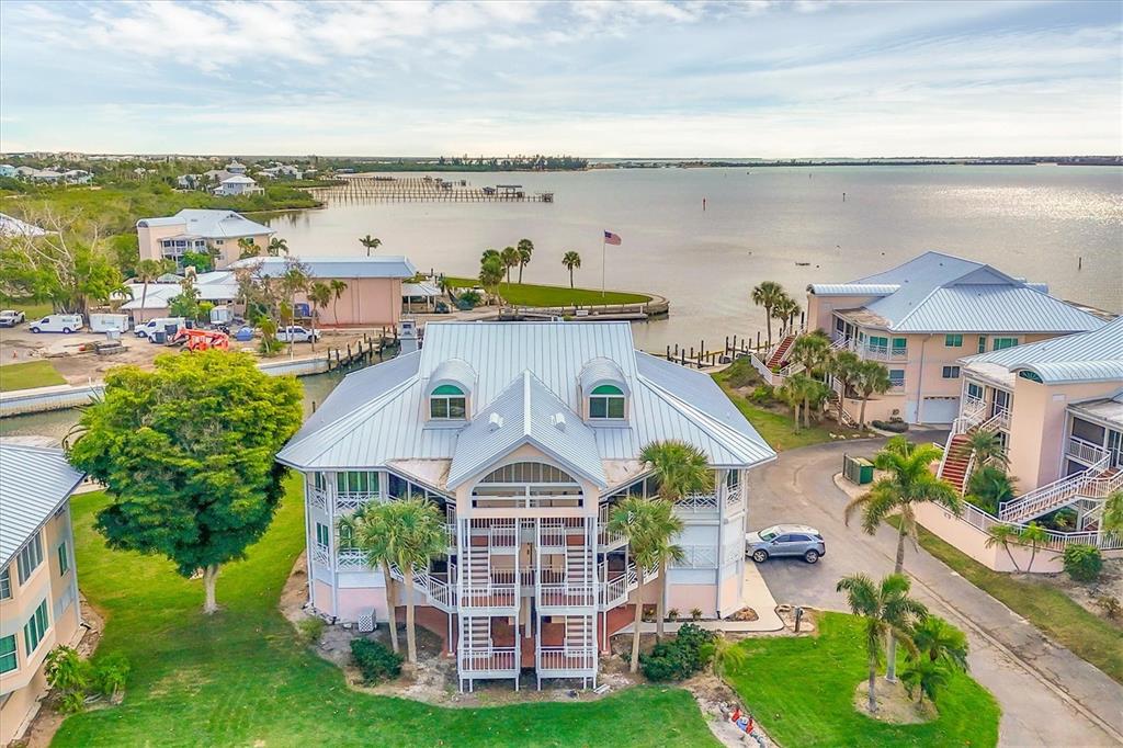 a front view of a house with a yard and lake view