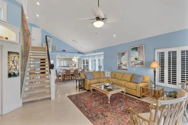 a living room with furniture and floor to ceiling windows