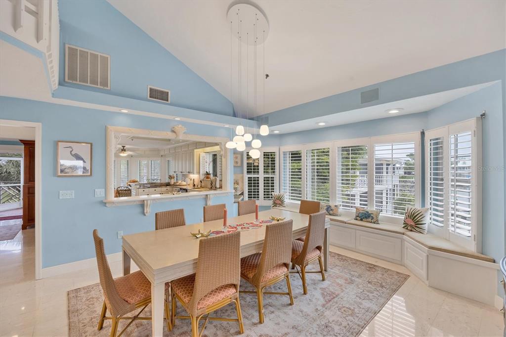 11000 Placida Road, Unit 2103 Placida, FL 33946 - Photo 14 of 63 a dining room with furniture a chandelier and large window