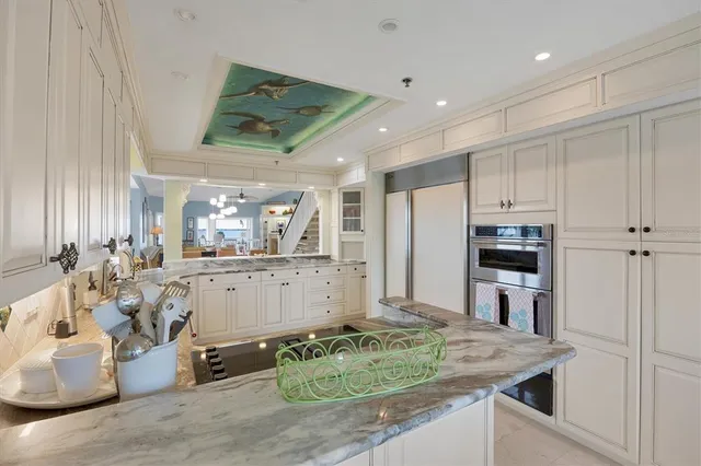 a living room with furniture and floor to ceiling windows