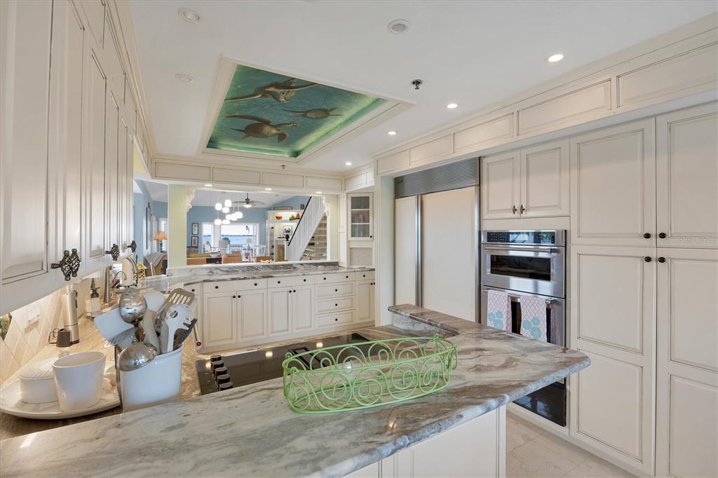 11000 Placida Road, Unit 2103 Placida, FL 33946 - Photo 19 of 63 a large kitchen with kitchen island a stove a sink dishwasher and refrigerator with wooden floor