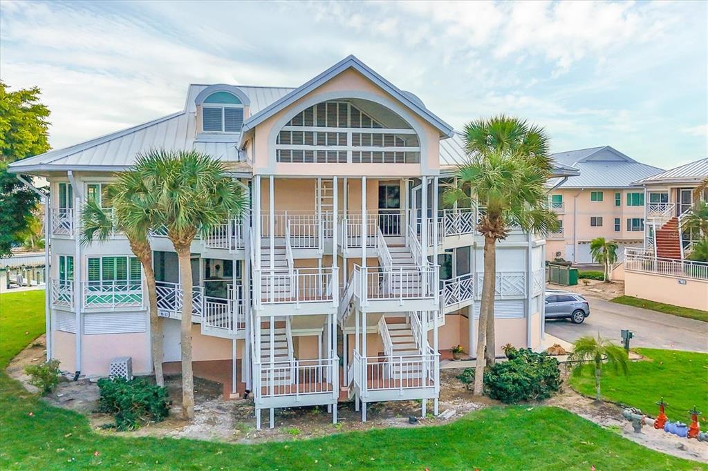 11000 Placida Road, Unit 2103 Placida, FL 33946 - Photo 2 of 63 a front view of a house with a yard