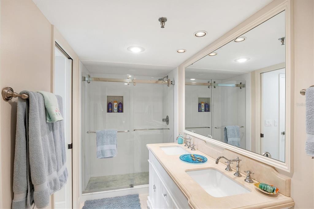 11000 Placida Road, Unit 2103 Placida, FL 33946 - Photo 31 of 63 a bathroom with a granite countertop double vanity sink mirror and shower