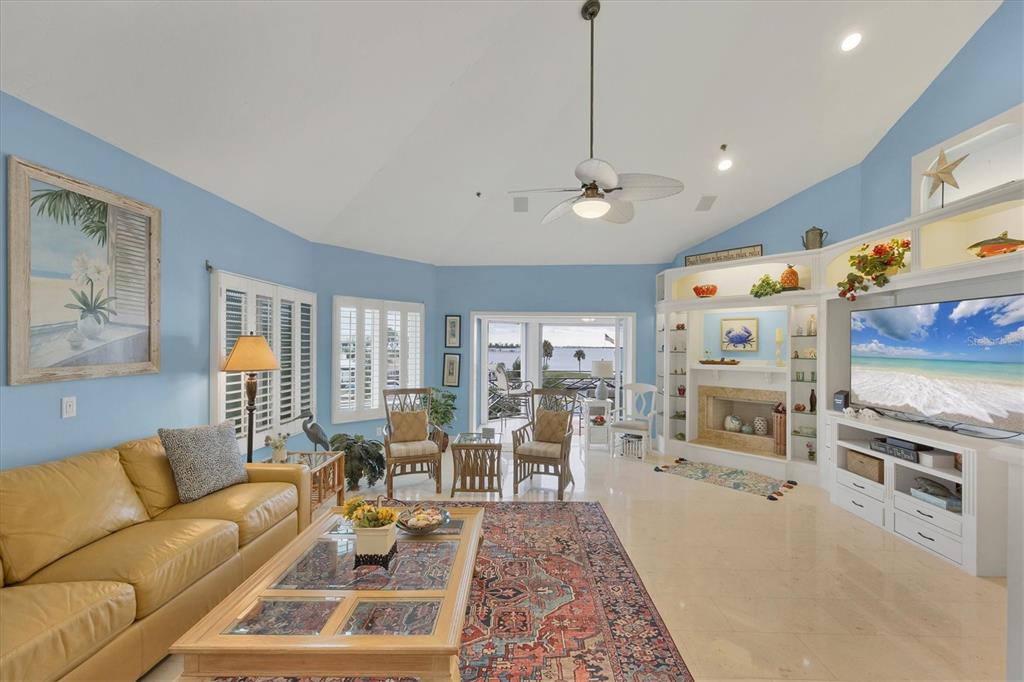 11000 Placida Road, Unit 2103 Placida, FL 33946 - Photo 7 of 63 a living room with furniture flat screen tv and a fireplace