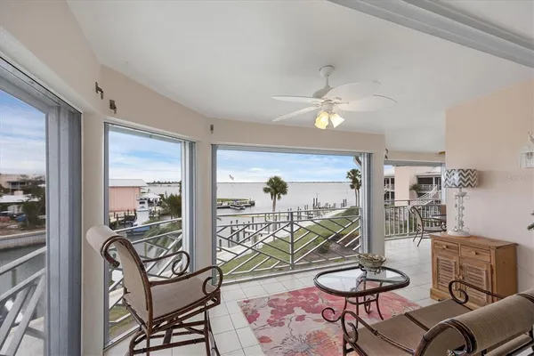 a view of a balcony with dining table and chairs with wooden floor