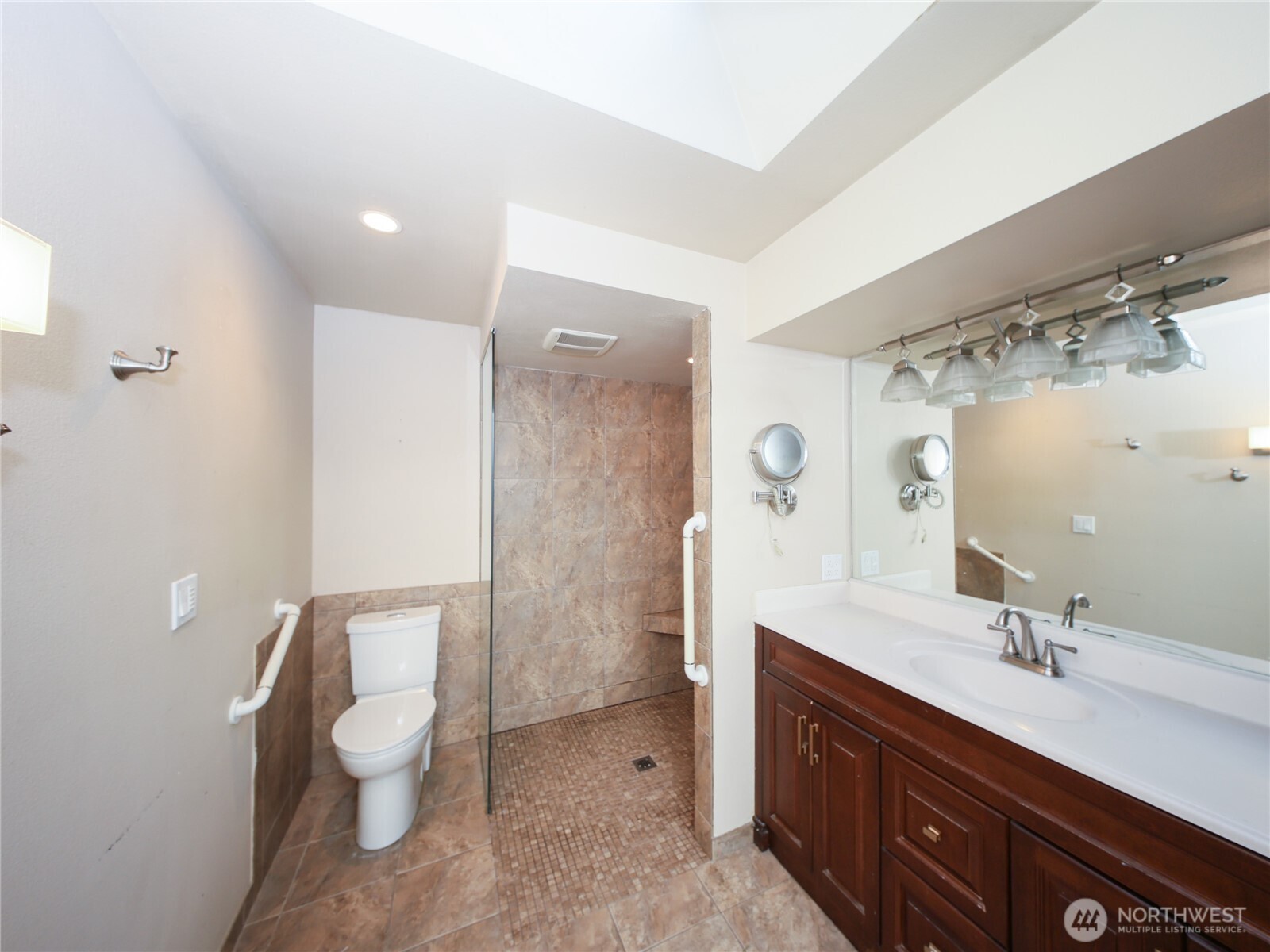 3413 Alaska Road Brier, WA 98036 - Photo 13 of 26 a spacious bathroom with a double vanity sink toilet and a mirror