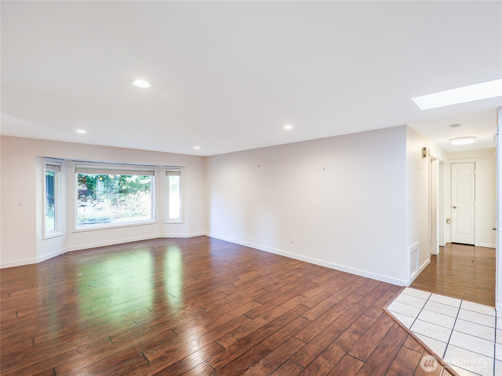 3413 Alaska Road Brier, WA 98036 - Photo 6 of 26 a view of an empty room with wooden floor and a window