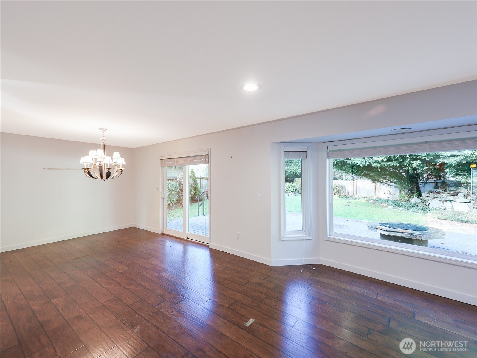 3413 Alaska Road Brier, WA 98036 - Photo 7 of 26 an empty room with wooden floor and windows