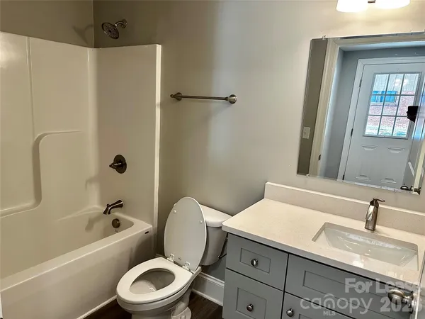 a bathroom with a sink a toilet and a bathtub