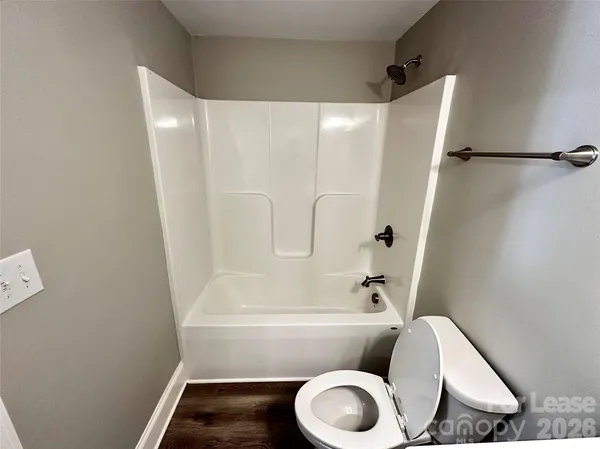 a bathroom with a toilet and a bathtub