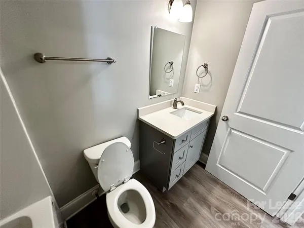 a spacious bathroom with a toilet sink and mirror