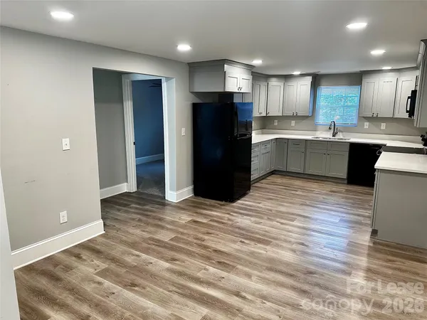 a kitchen with a refrigerator and a stove top oven