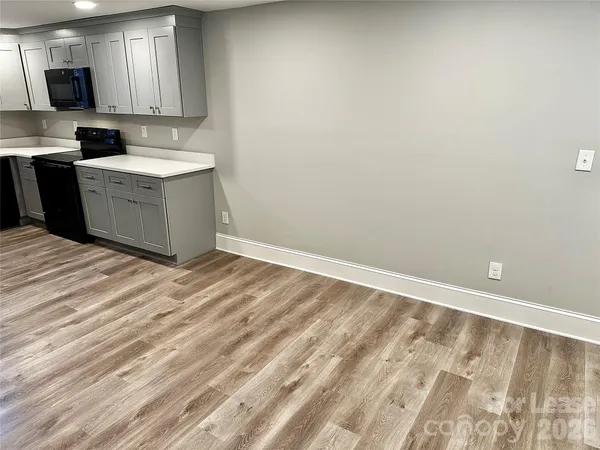 a room with a sink and a microwave