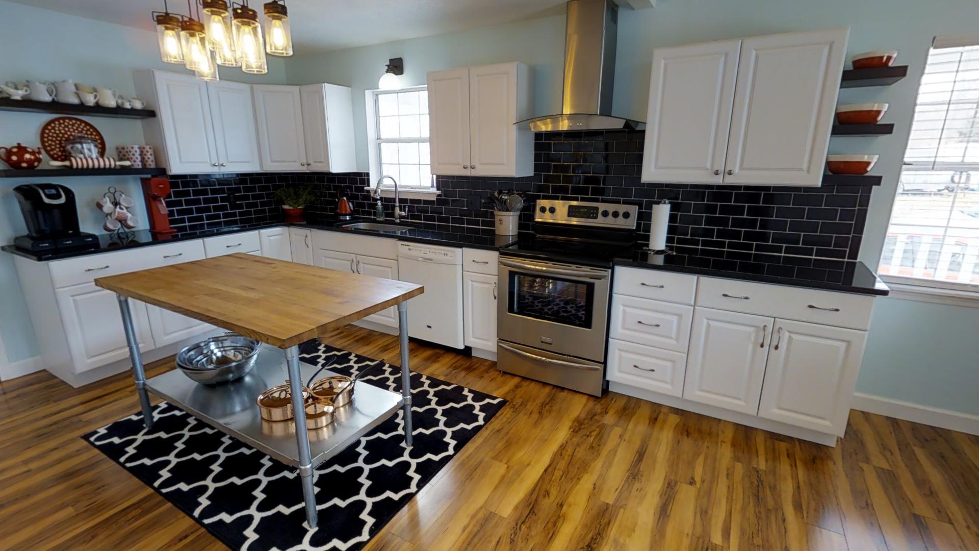 4811 Joe Peay Road Spring Hill, TN 37174 - Photo 4 of 19 a kitchen with stainless steel appliances a stove a sink and cabinets