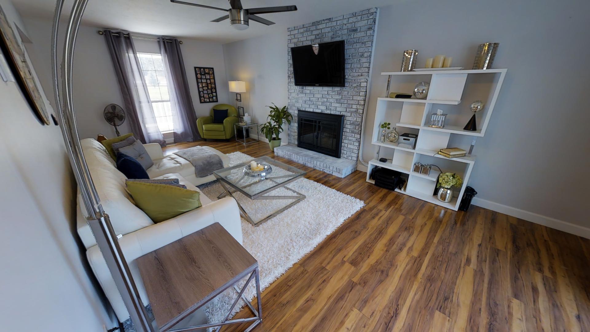 4811 Joe Peay Road Spring Hill, TN 37174 - Photo 8 of 19 a living room with furniture fireplace and flat screen tv