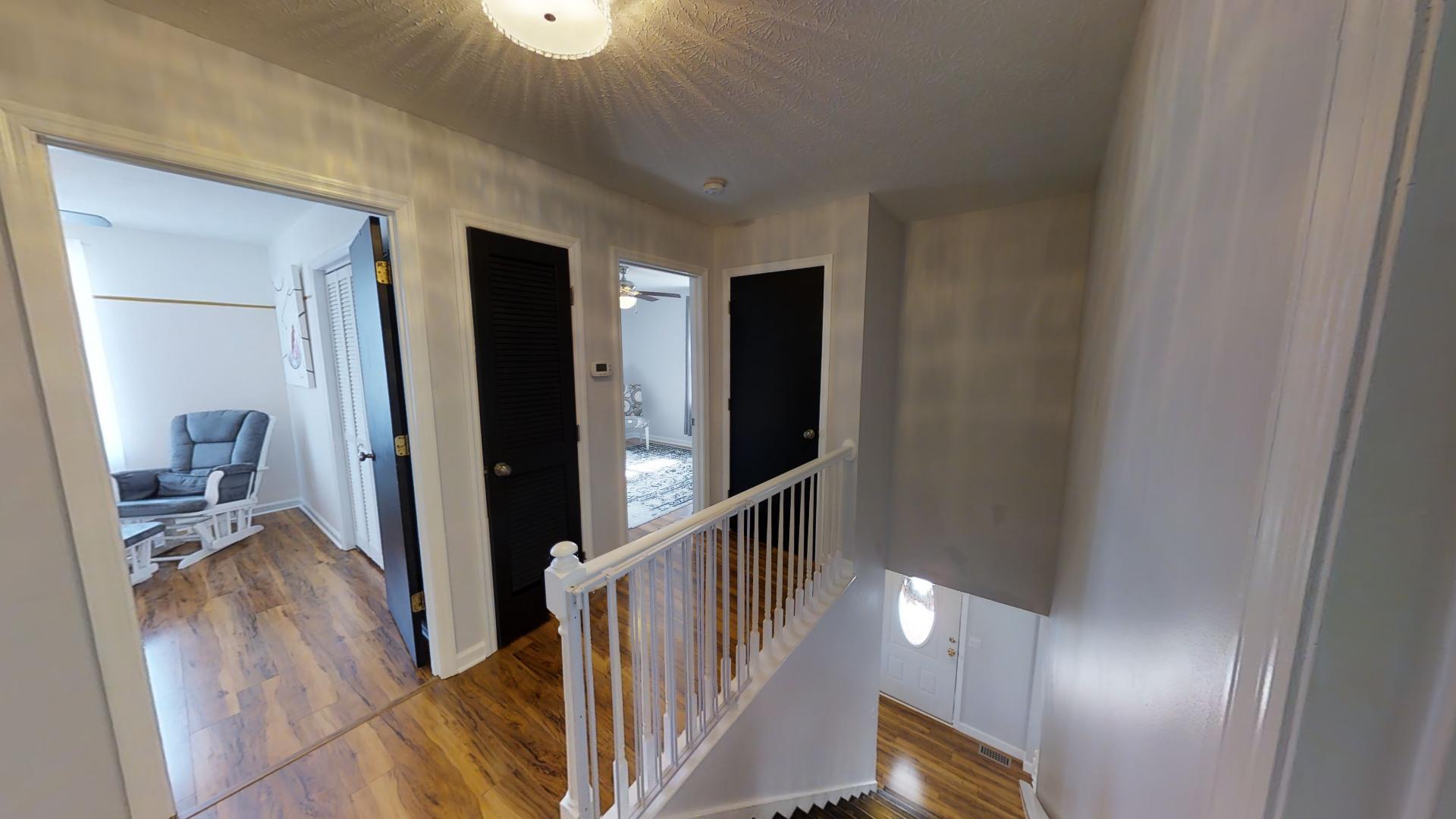 4811 Joe Peay Road Spring Hill, TN 37174 - Photo 10 of 19 a view of a hallway with wooden floor and stairs