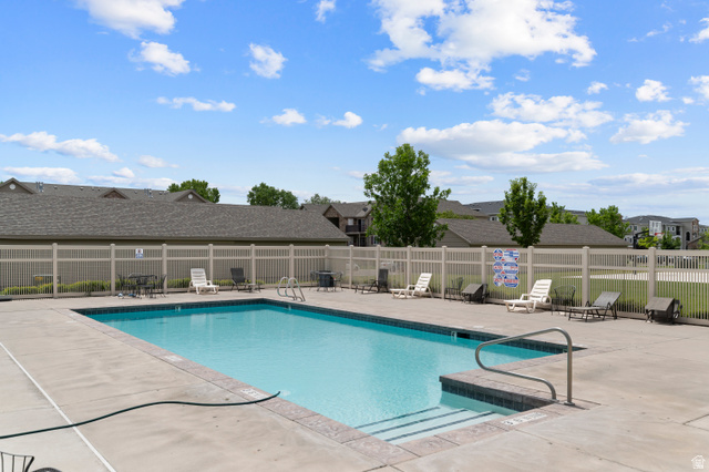 25 West Ridge Road, Unit 25 Saratoga Springs, UT 84045 - Photo 22 of 22 Outdoor swimming pool with a surrounding concrete deck and a light-toned privacy fence