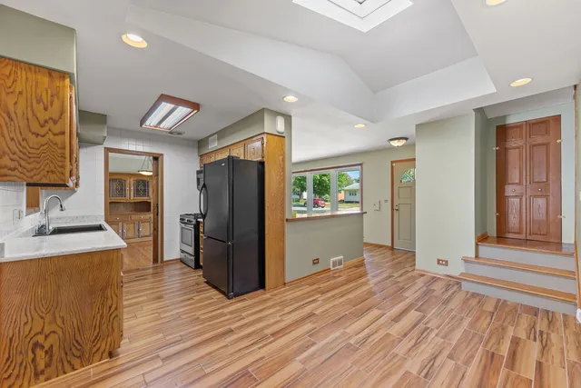 a view of a refrigerator in kitchen and wooden floor