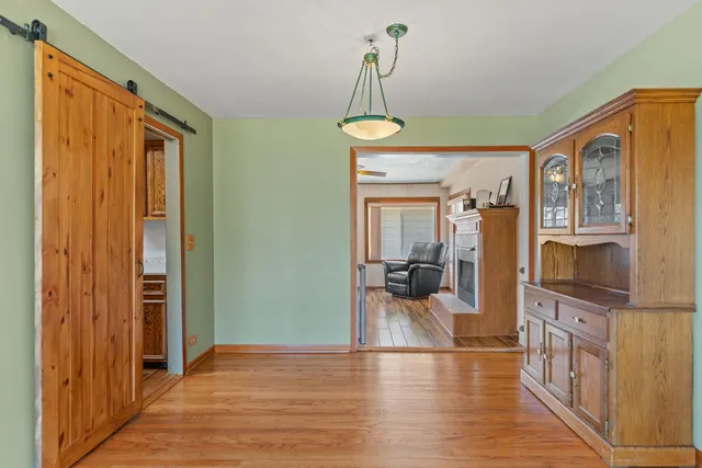 a view of a livingroom with furniture wooden floor windows and a chandelier
